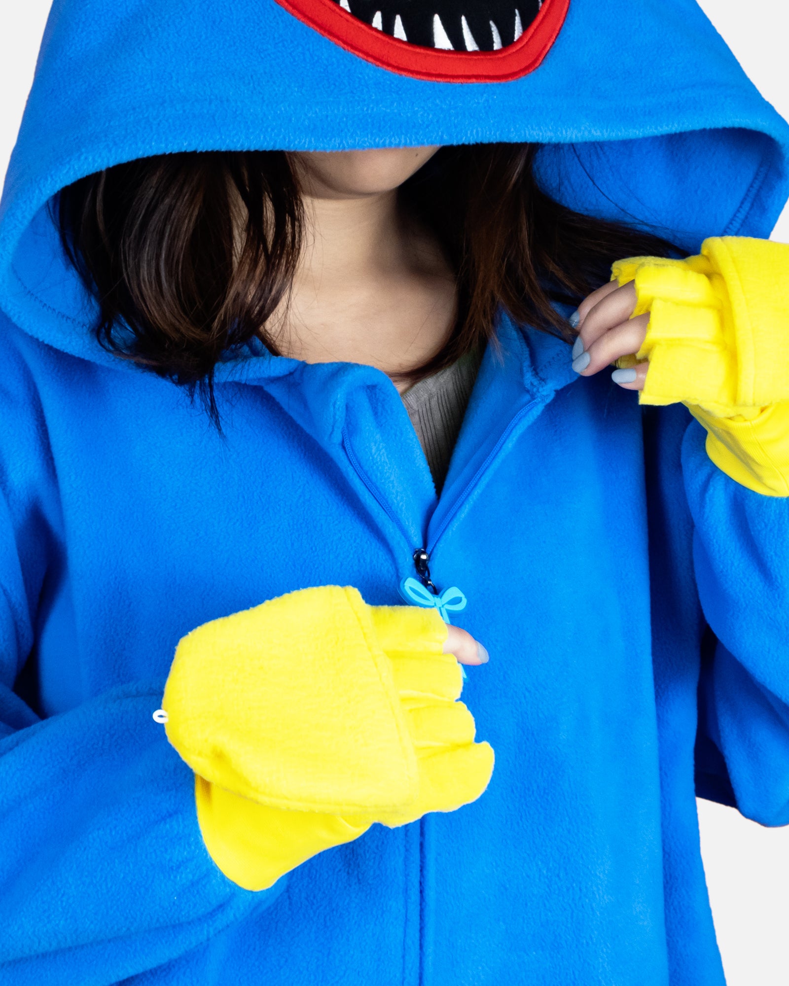 huggy wuggy onesie zips up on front. zipper has little bow tie on it. hands convert from mittens to fingerless gloves.