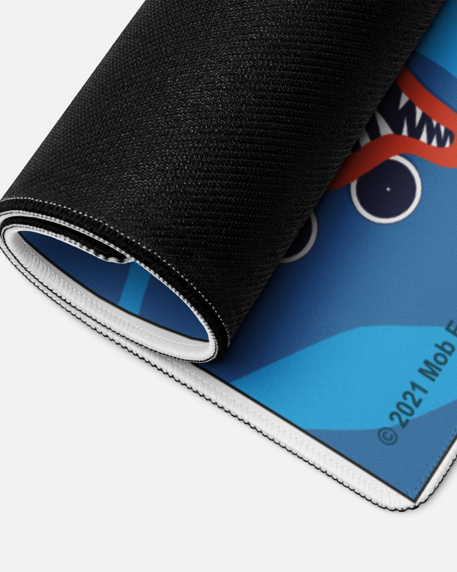 huggy wuggy gamer mousepad rolled up to show bottom material.