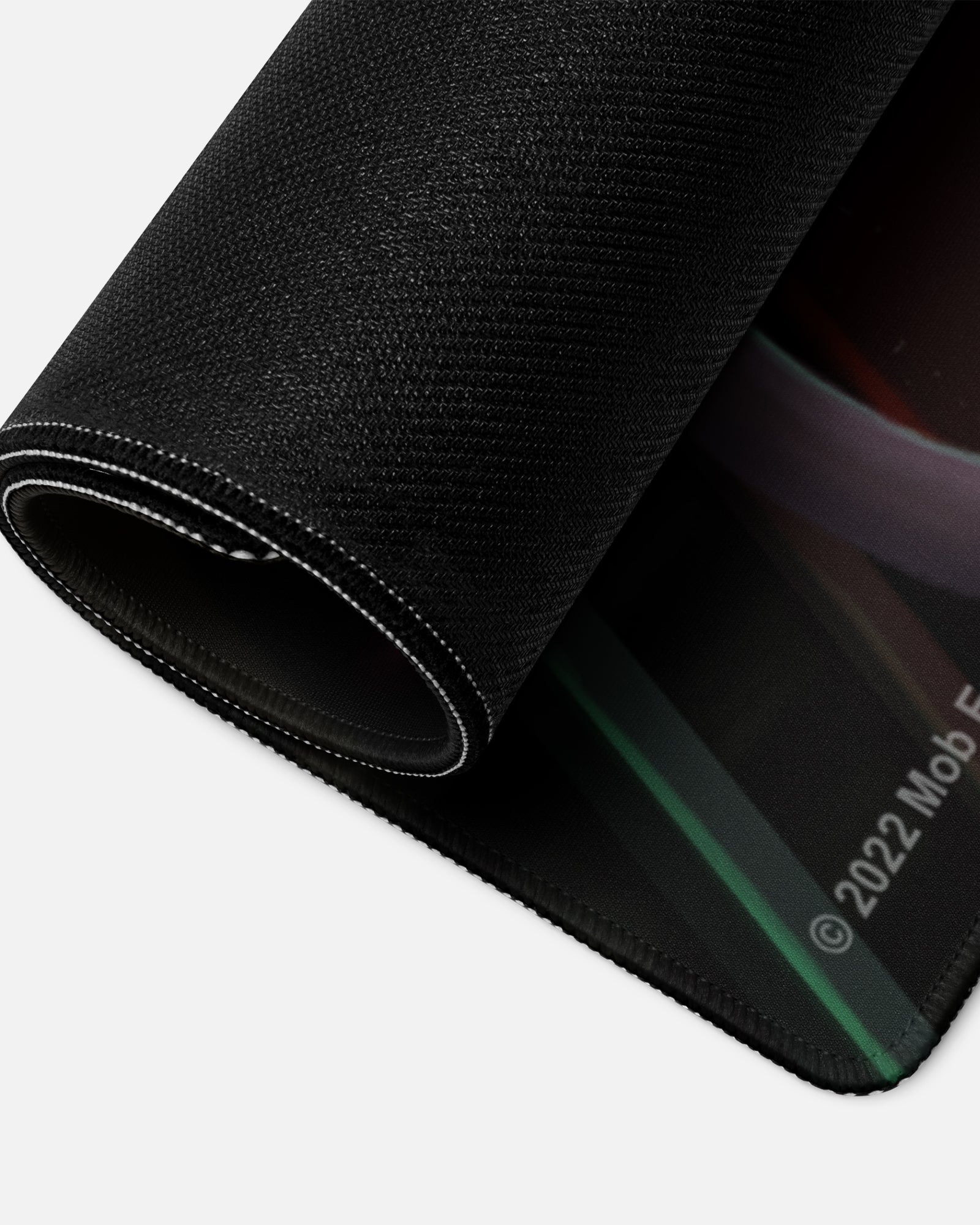 mommy longlegs gamer mousepad rolled up to show bottom material.