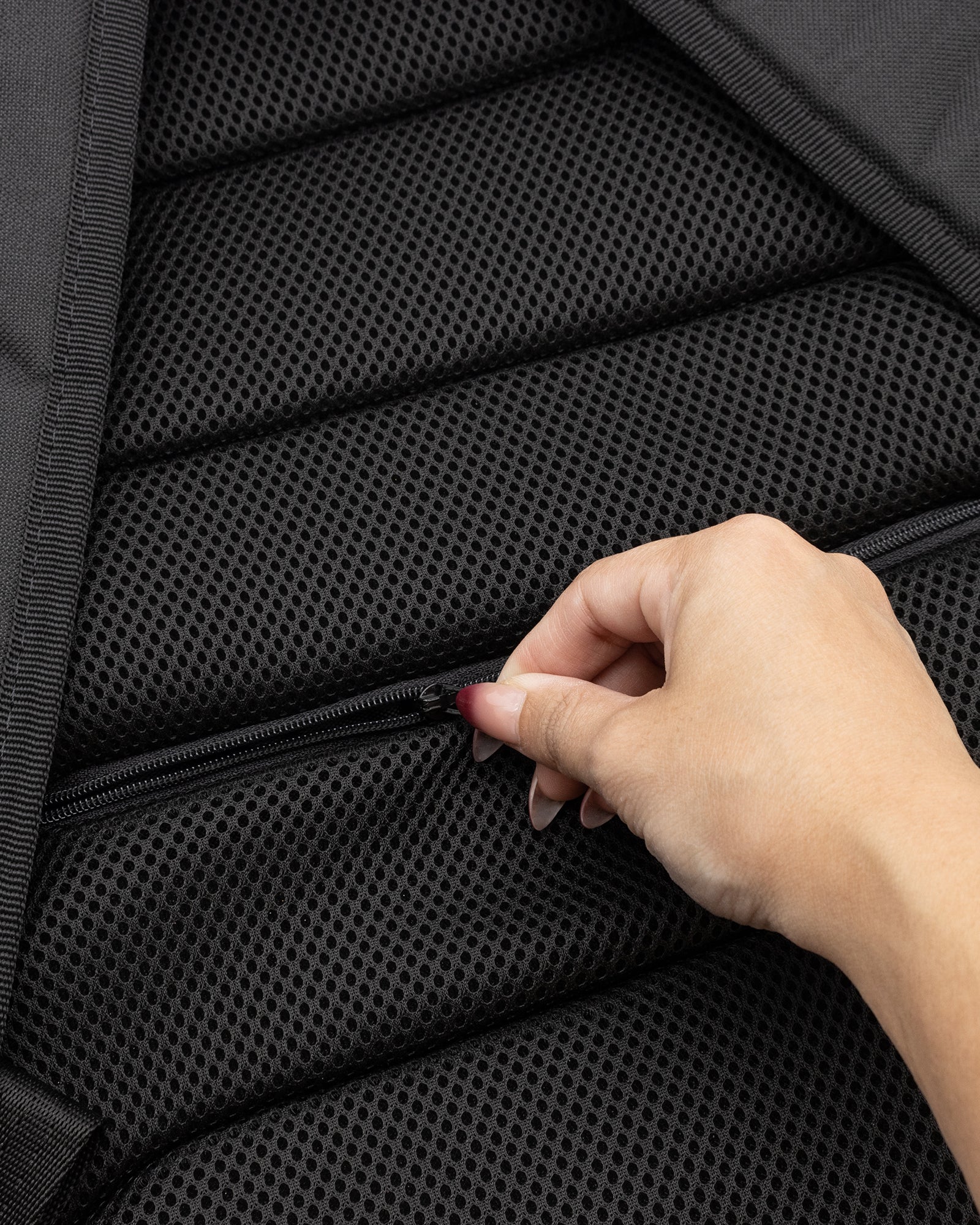 backpack back detail. zippered pocket on back.