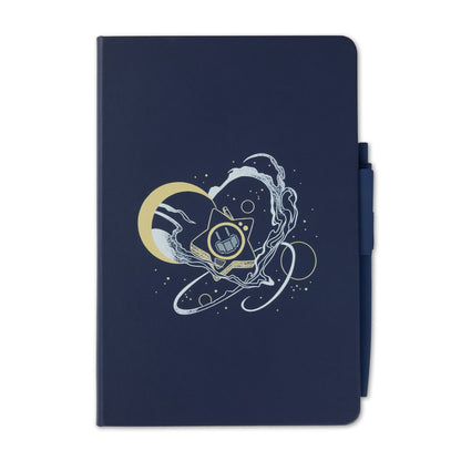 A navy blue notebook with a matching pen in its side pocket, featuring a central graphic of a gold crescent moon, Glowby, and white swirling cosmic lines.
