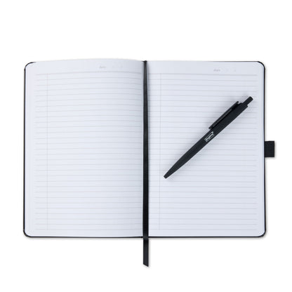An open notebook with a black pen resting diagonally across the pages.