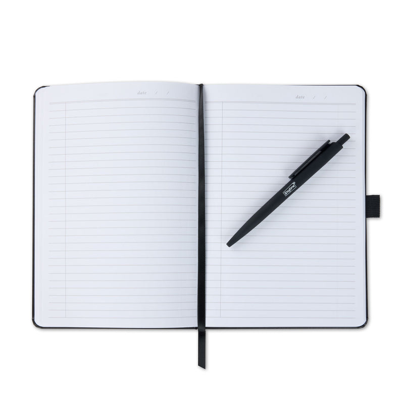 An open notebook with a black pen resting diagonally across the pages.
