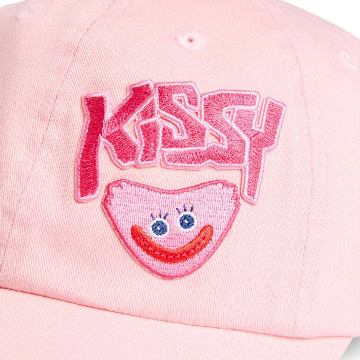 close up shot of embroidered Kissy text and smiling kissy missy face.