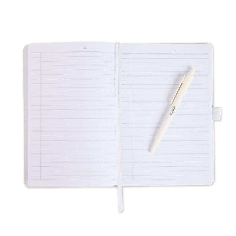 An open white notebook with a white pen resting diagonally across the pages.