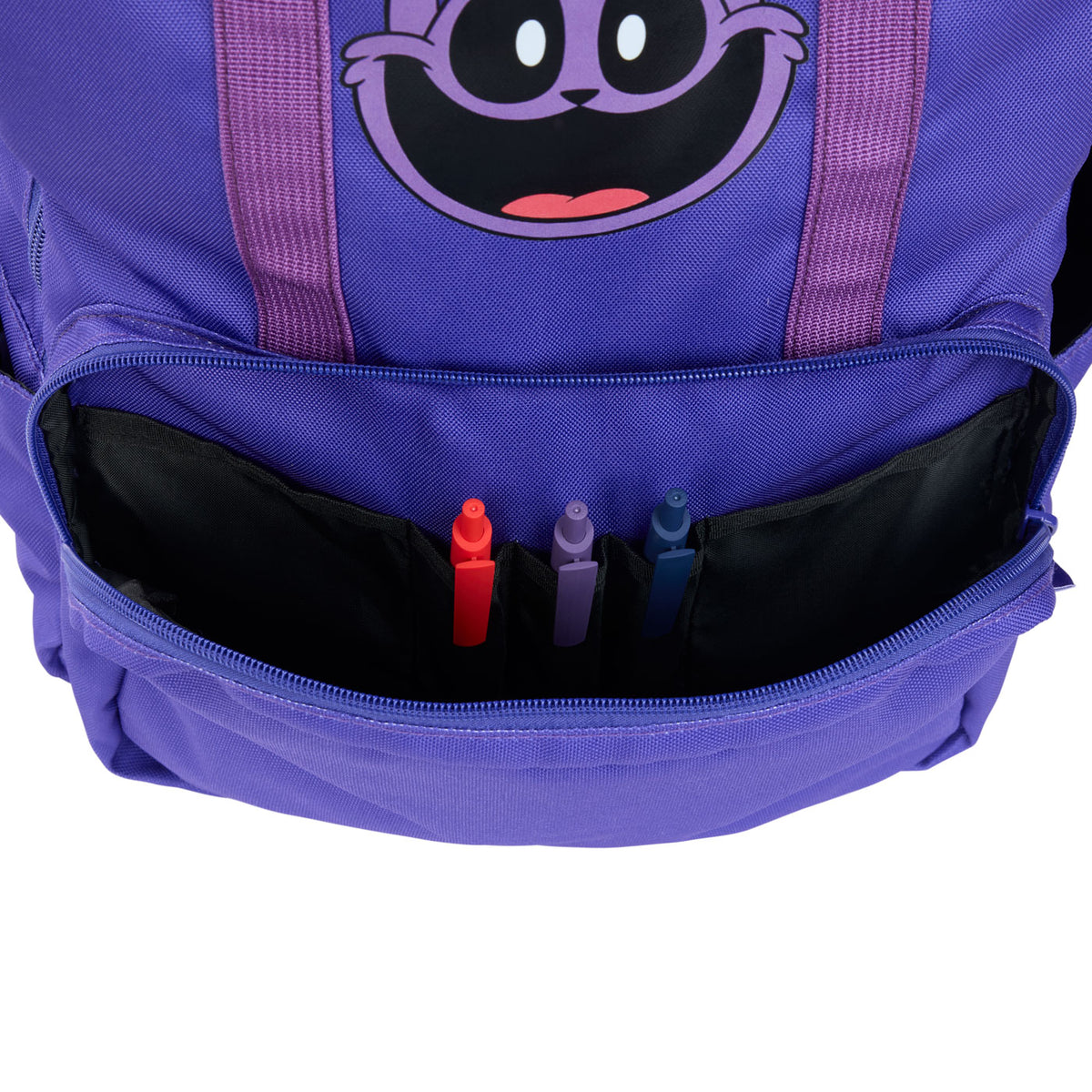 Close-up of a purple backpack with a cartoon face graphic and an open front zip pocket holding three markers.