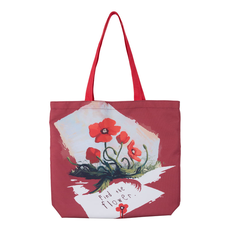 A red tote bag with red shoulder straps, featuring a printed graphic of red poppies on white paper with the handwritten text 'Find the flower.'