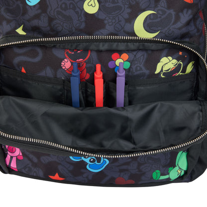 Close-up of a black backpack with smiling critters character prints, showing an open front compartment holding three pens inside.