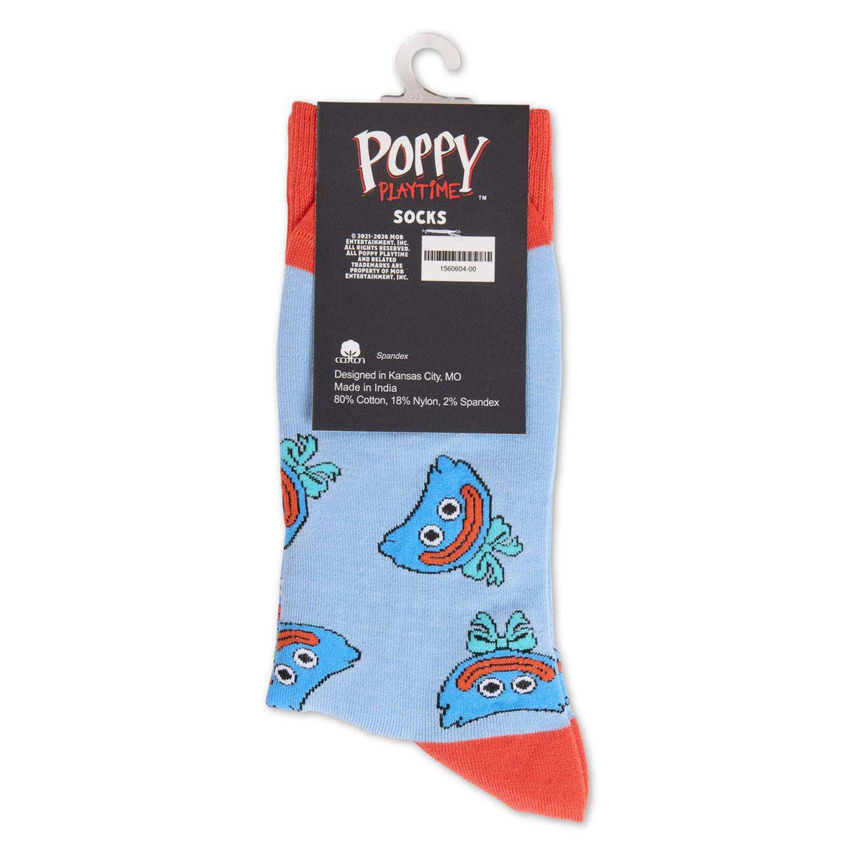 A pair of light blue novelty socks with a repeating smiling huggy wuggy  face pattern and coral-red toes and heels, hanging from a white plastic hanger with a black Poppy Playtime brand label.