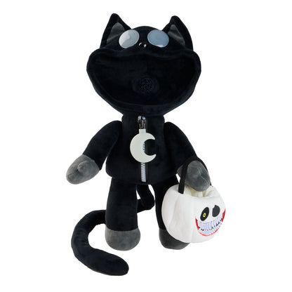 A black plush cat toy wearing a black zip-up suit with a white crescent moon emblem, holding a white skull-shaped bucket bag with a grinning face.