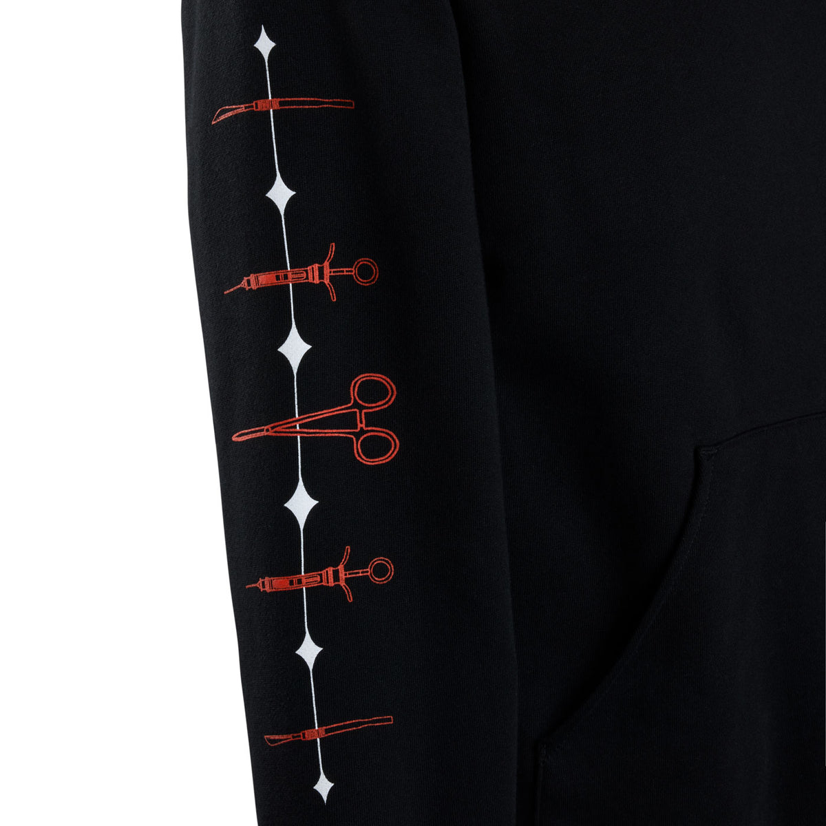 A close-up of a black sweatshirt sleeve featuring a vertical black line of surgical instrument.