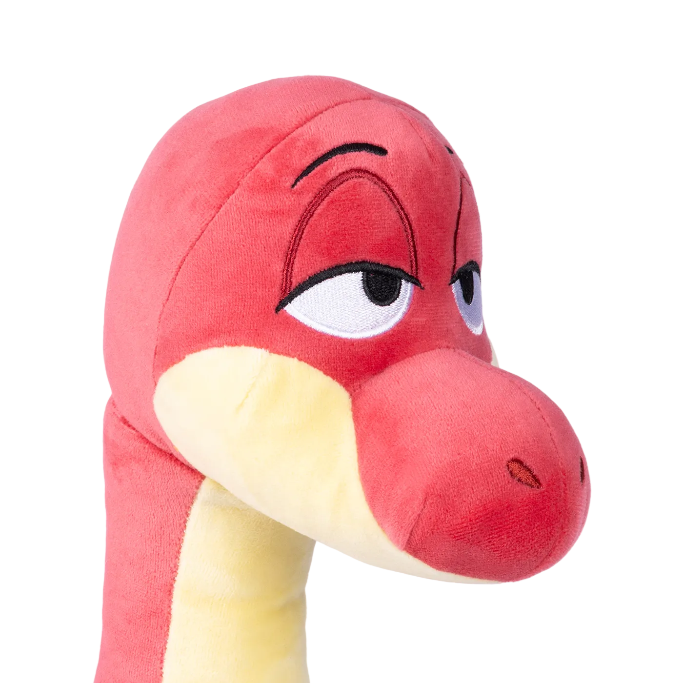 A close-up of BRON plush toy with a yellow neck and embroidered eyes.