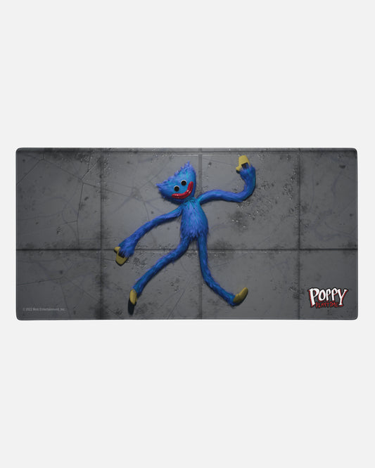smiling huggy wuggy gamer mousepad. image: smiling huggy wuggy plush sprawled on concrete floor. text: poppy playtime